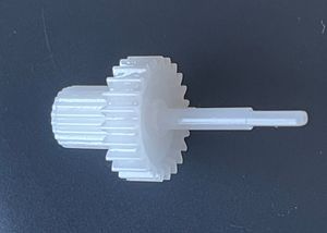 The final output gear also couples into the potentiometer via a flat-ended interface, making it part of both the mechanical output path and the position feedback system.