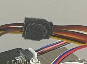 Closeup of a hook and loop cable tie wrapped around a bundle of wires