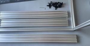 A corner bracket fitted to two lengths of aluminium extrusion